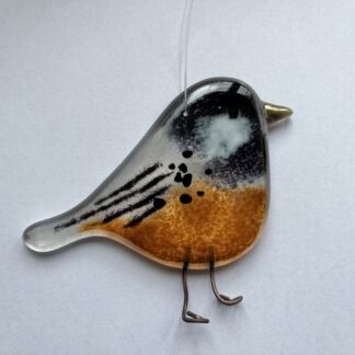 Coal tit hanging bird